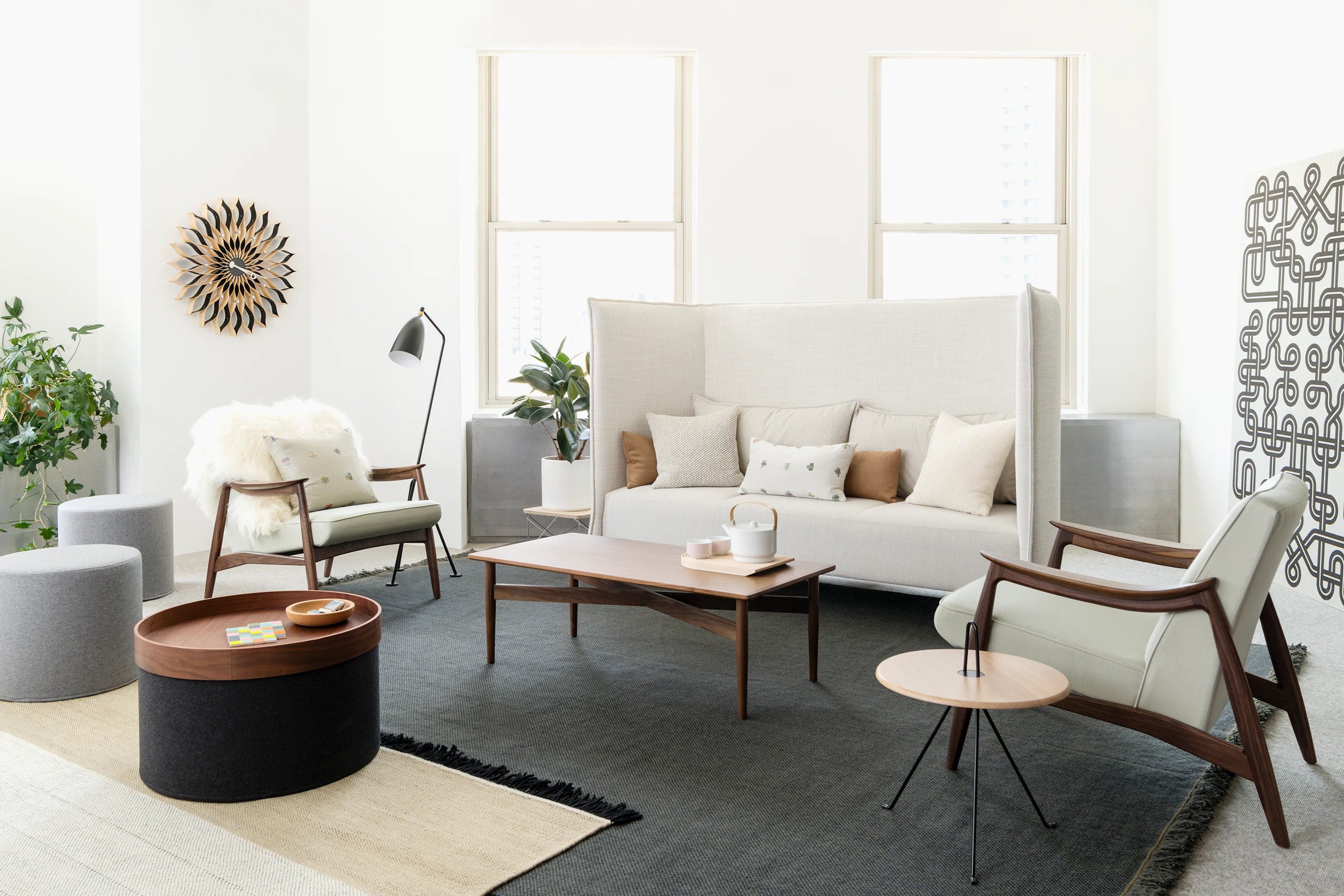 Bright lounge seating area with high-back sofa and two Aspen Lounge Chairs around a wood coffee table. Neocon 2018.