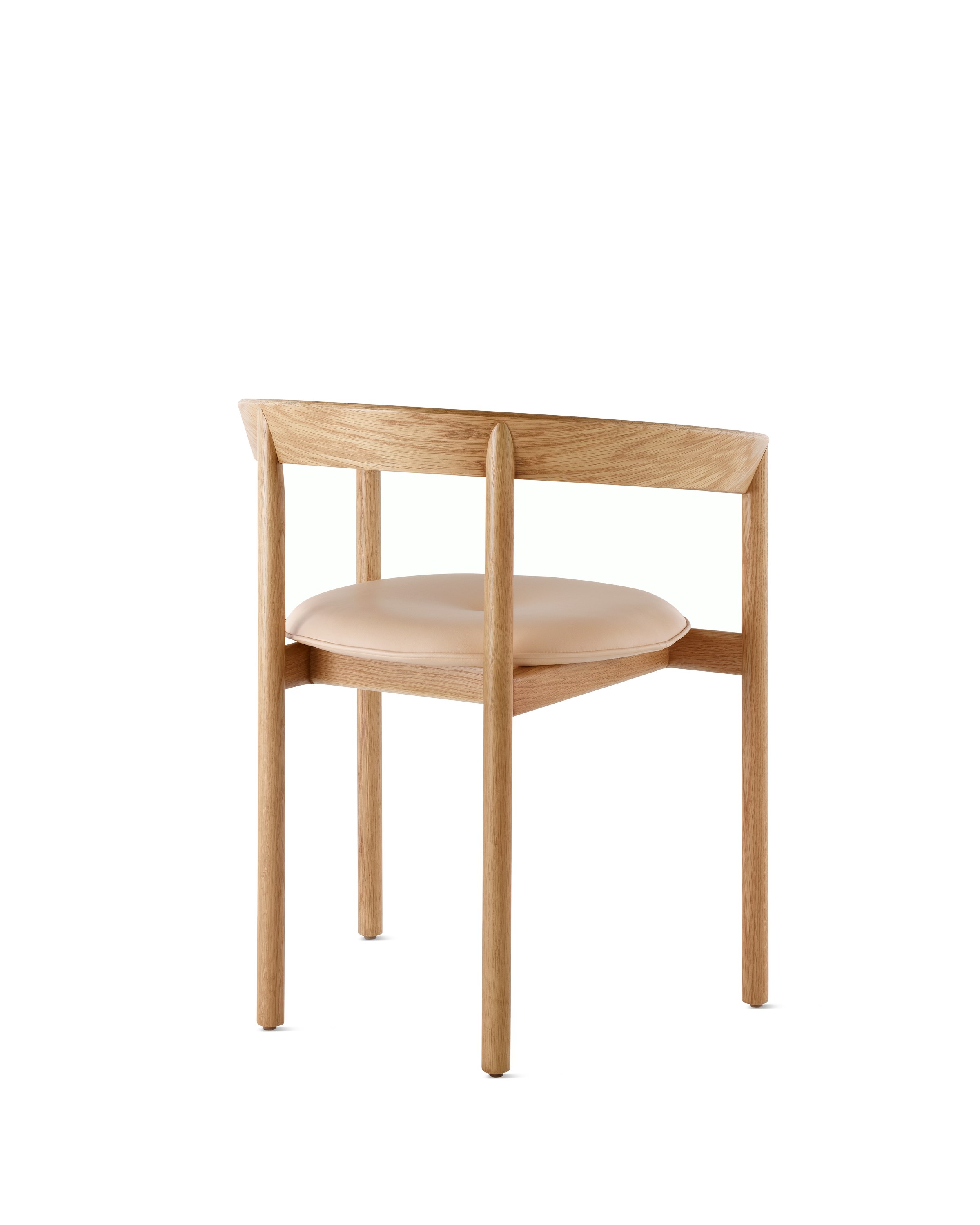 An oak Comma Chair with arms and a seat pad, viewed from the back at an angle.
