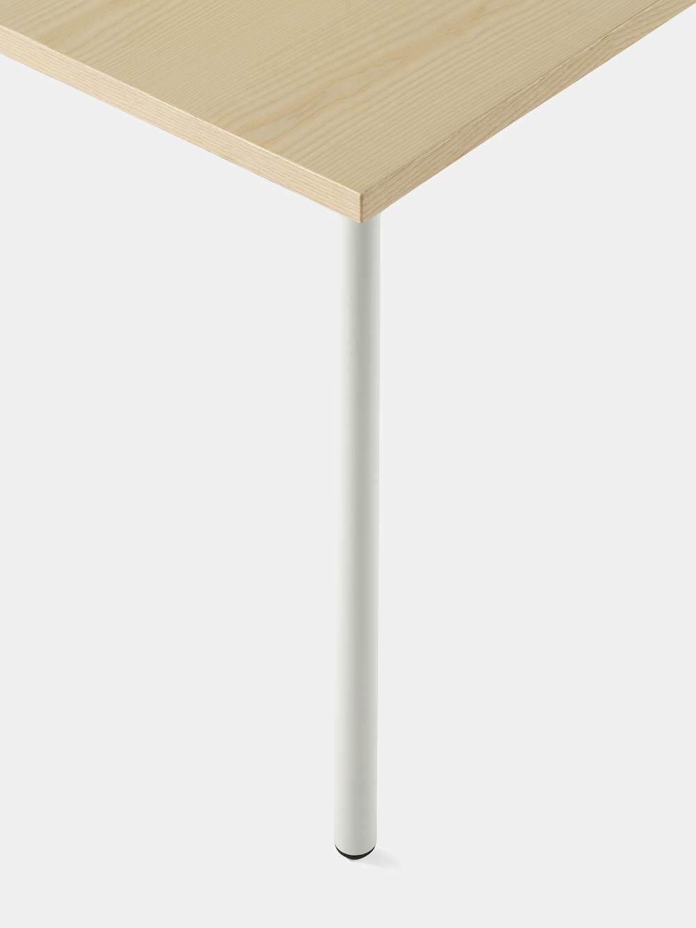 OE1 Rectangular Table with light brown surface and white legs with an up close view of the rounded leg.