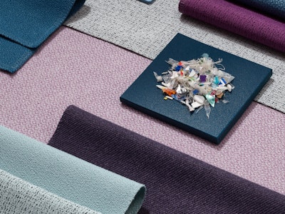 A pile of small plastics on top of a variety of textile samples.
