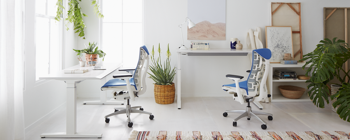 Two Embody Chairs at standing desks in a home office setting