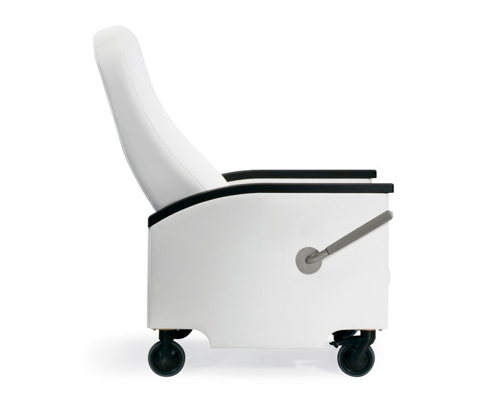 A side view of a Prísto Plus Recliner in a white upholstery with black urethane arm caps in a slightly reclined position.