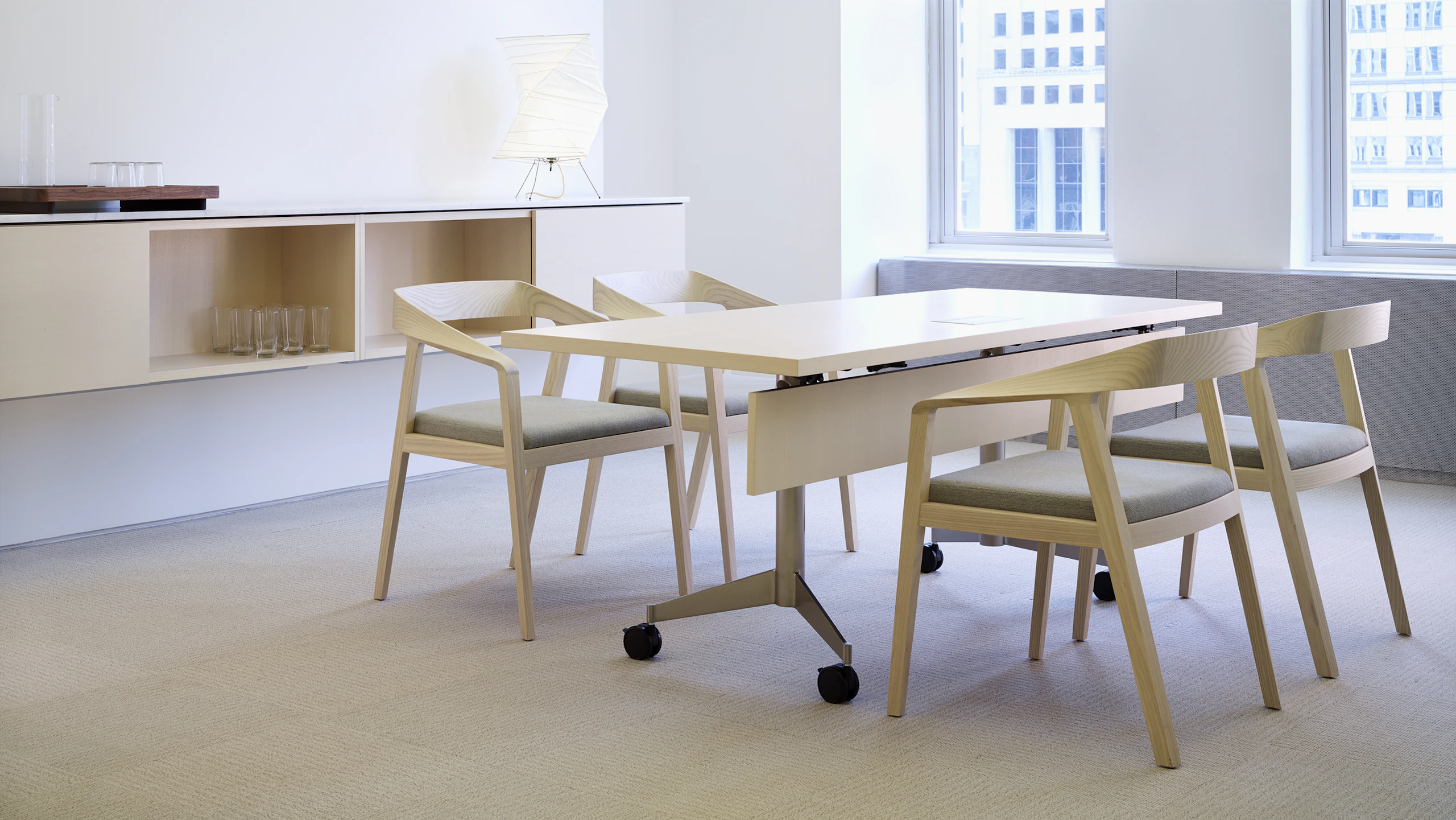 A MP Flex Table with four Full Twist Guest Chairs with seats upholstered in a Epingle textile.