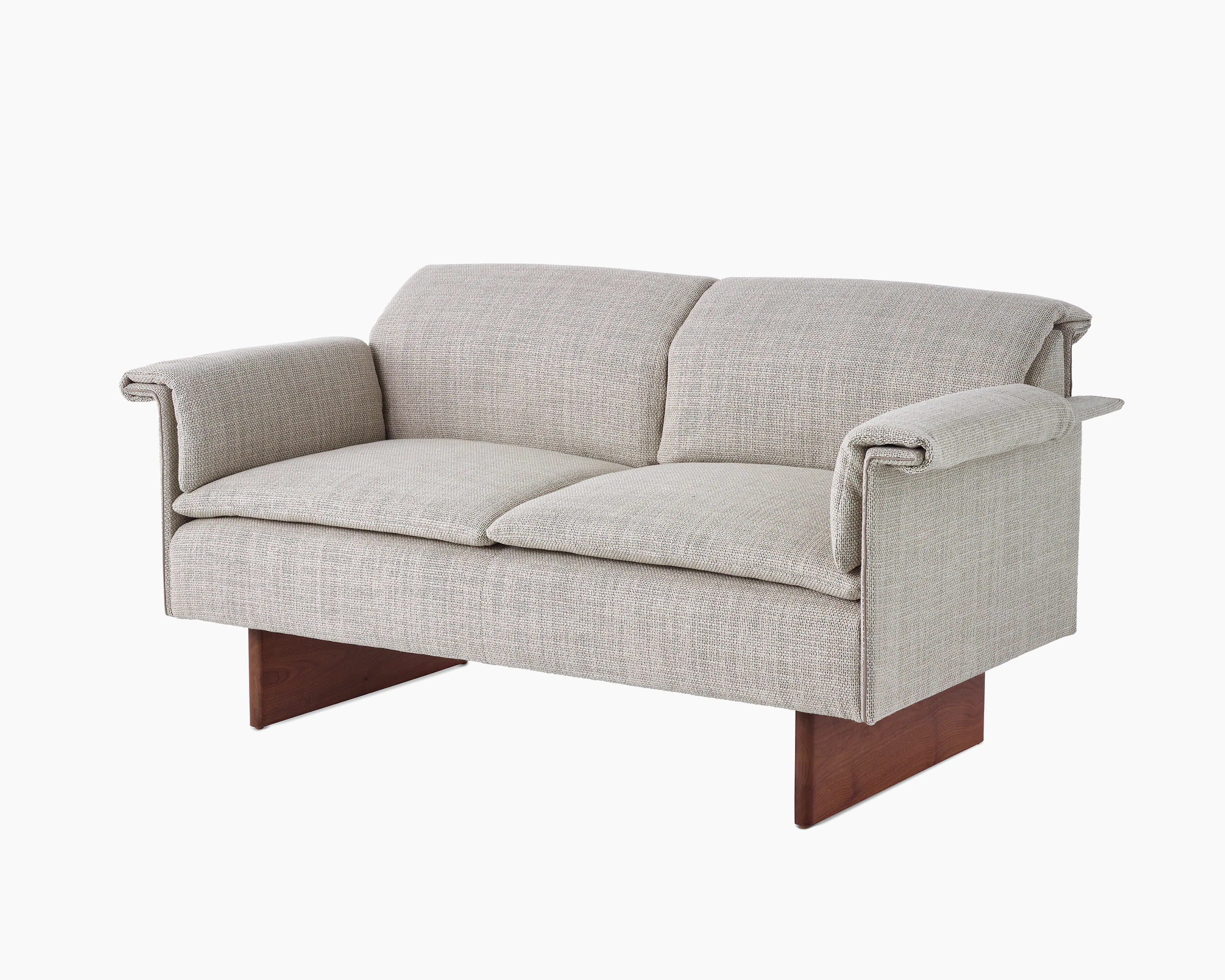 Mantle Two Seater Sofa in Capri Stone with Walnut Wood Base, viewed at an angle.