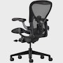 Black matte Aeron Chair on a white background with a 5-star base and ergonomic back support, angled view of the chair back.