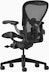 Black matte Aeron Chair on a white background with a 5-star base and ergonomic back support, angled view of the chair back.