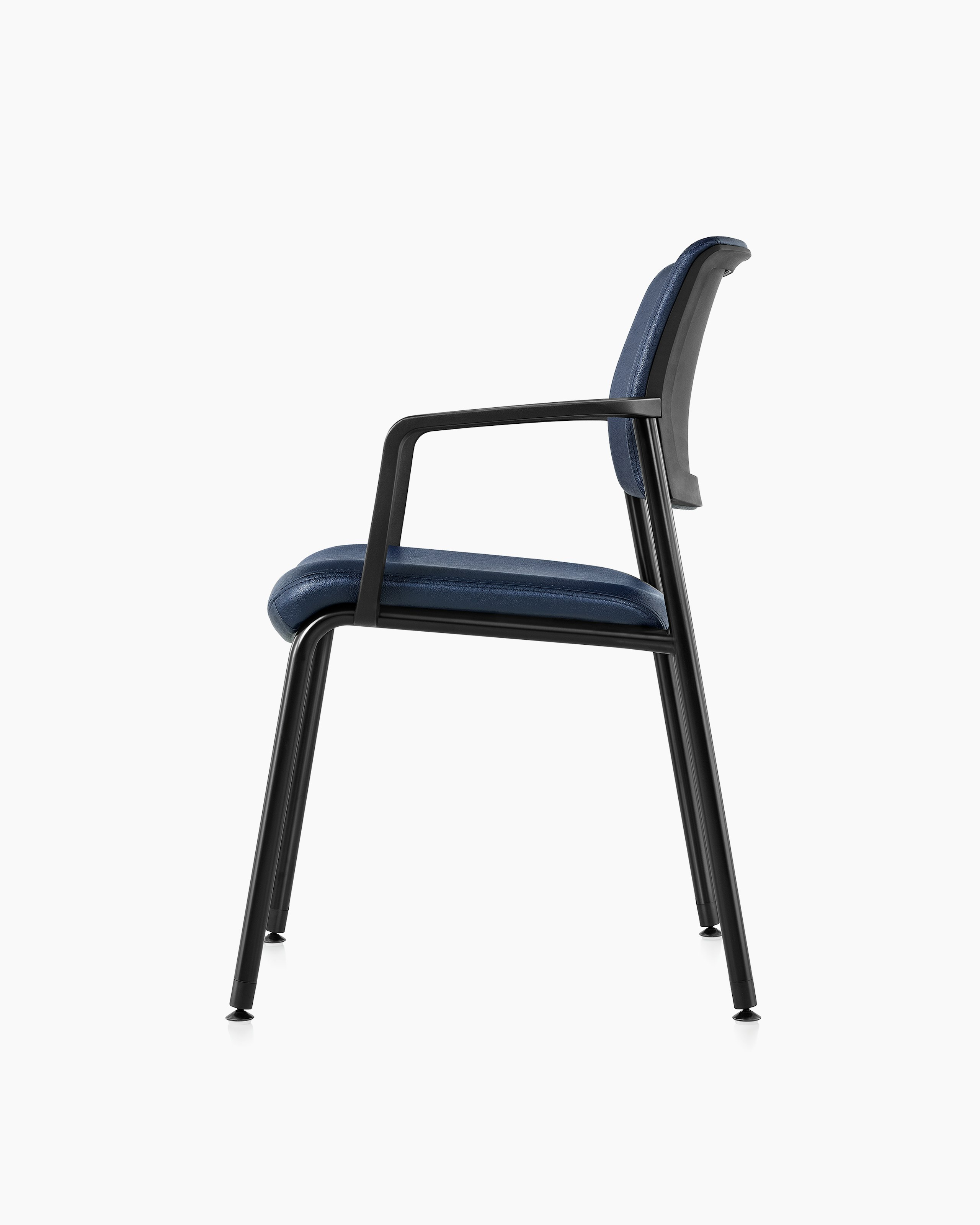 Side view, left, of the Verus Side Chair with arms, in blue vinyl upholstery.