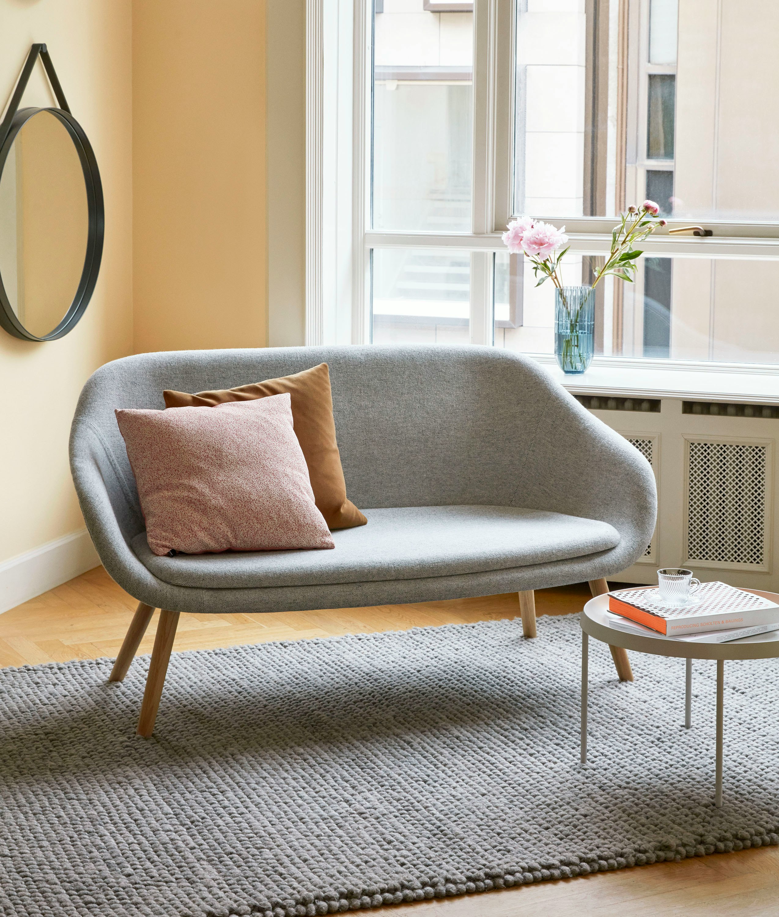 A grey About A Lounge Sofa in a living room space.