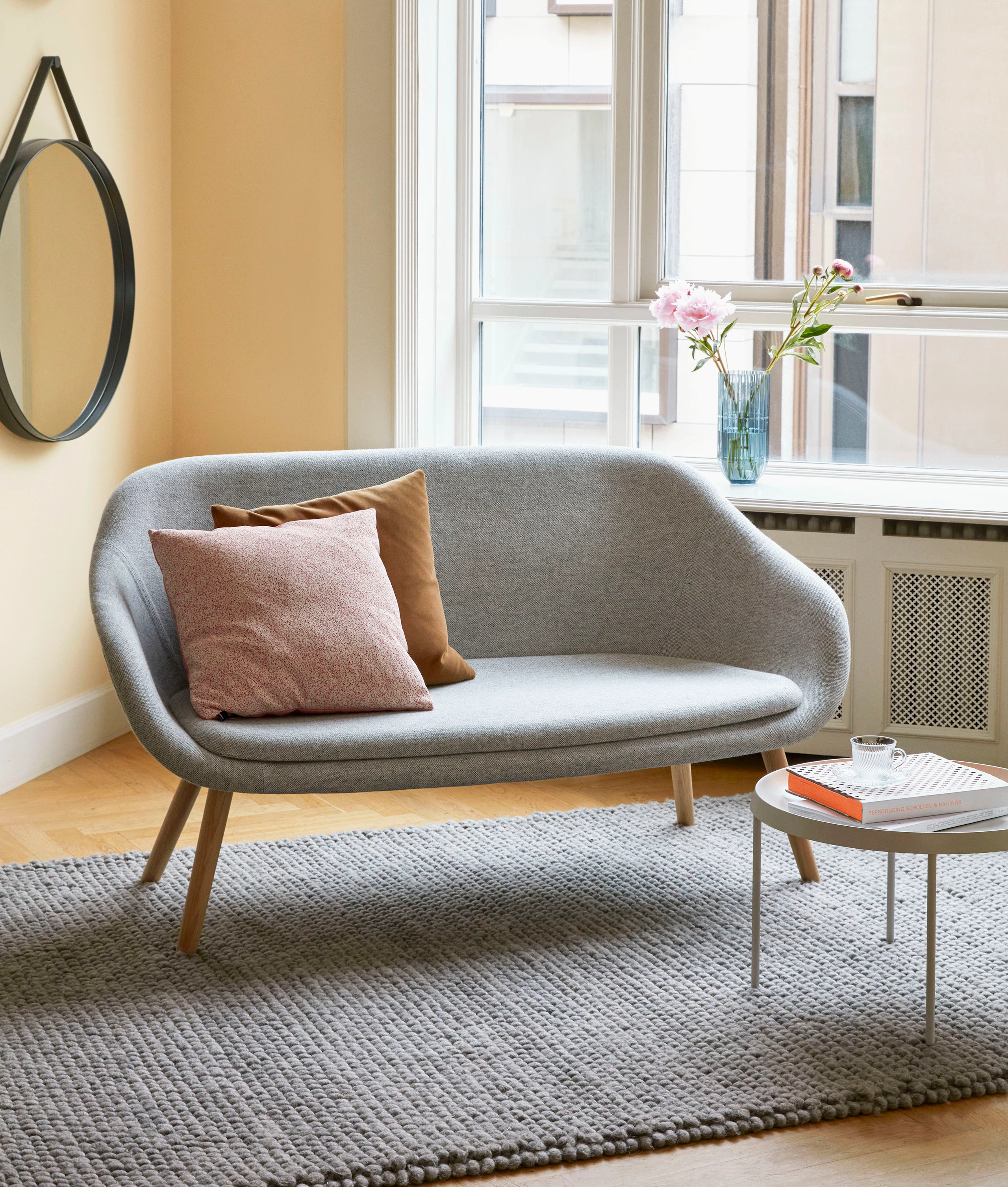 A grey About A Lounge Sofa in a living room space.