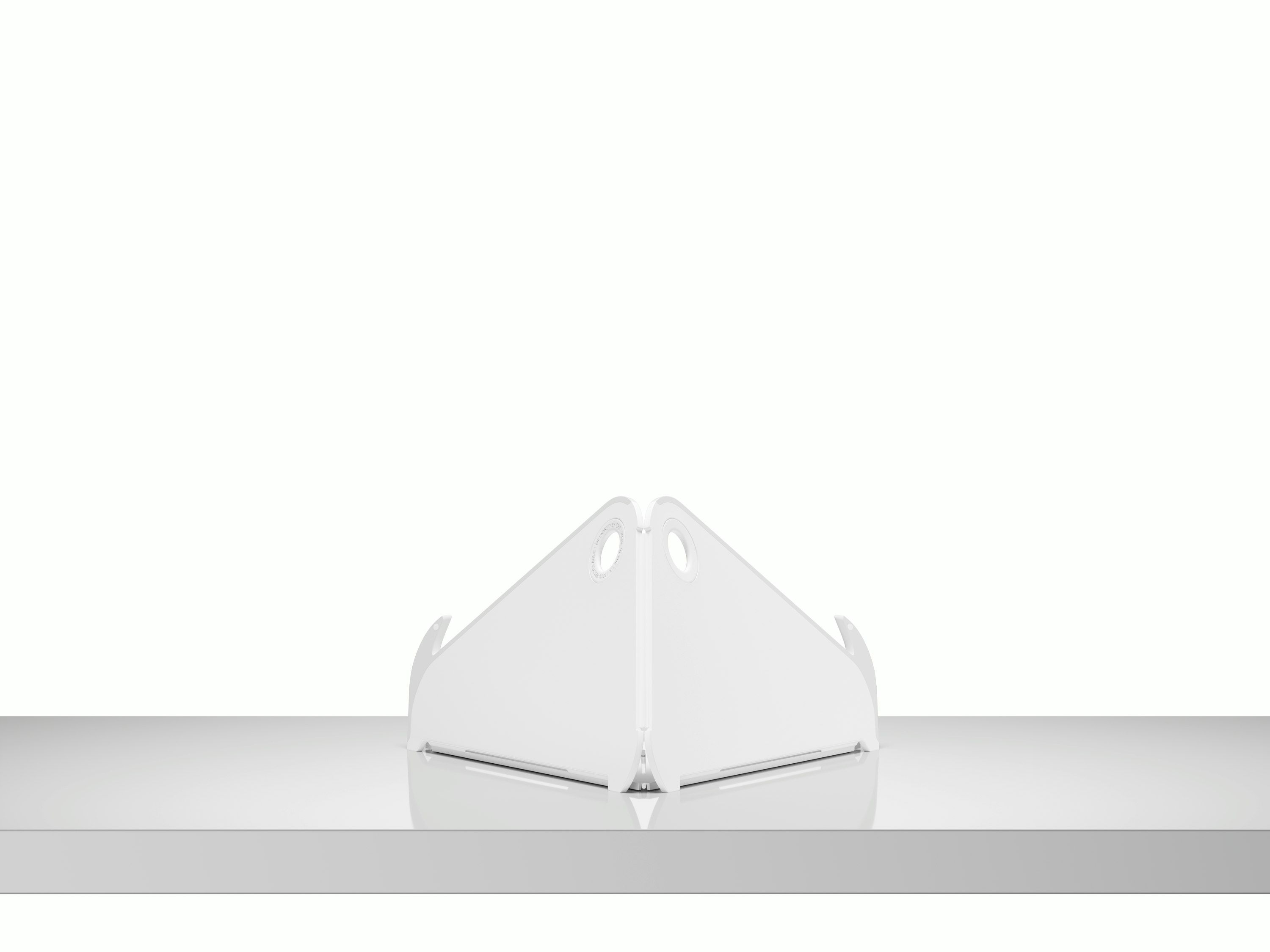 A back view of an open Oripura Laptop Stand on top of a worksurface.