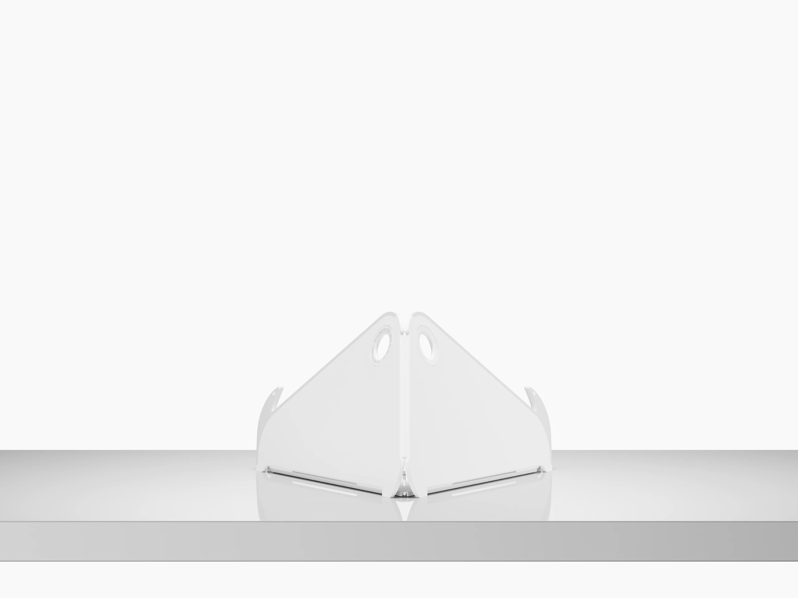 A back view of an open Oripura Laptop Stand on top of a worksurface.