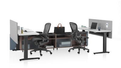 A Canvas Channel workstation by Herman Miller with two Aeron chairs