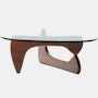 A Noguchi Table with a wood base and glass top.
