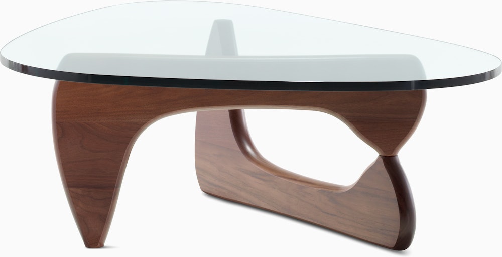 A Noguchi Table with a wood base and glass top.