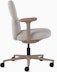 Side view of a mid-back Asari chair by Herman Miller in light brown with height adjustable arms.