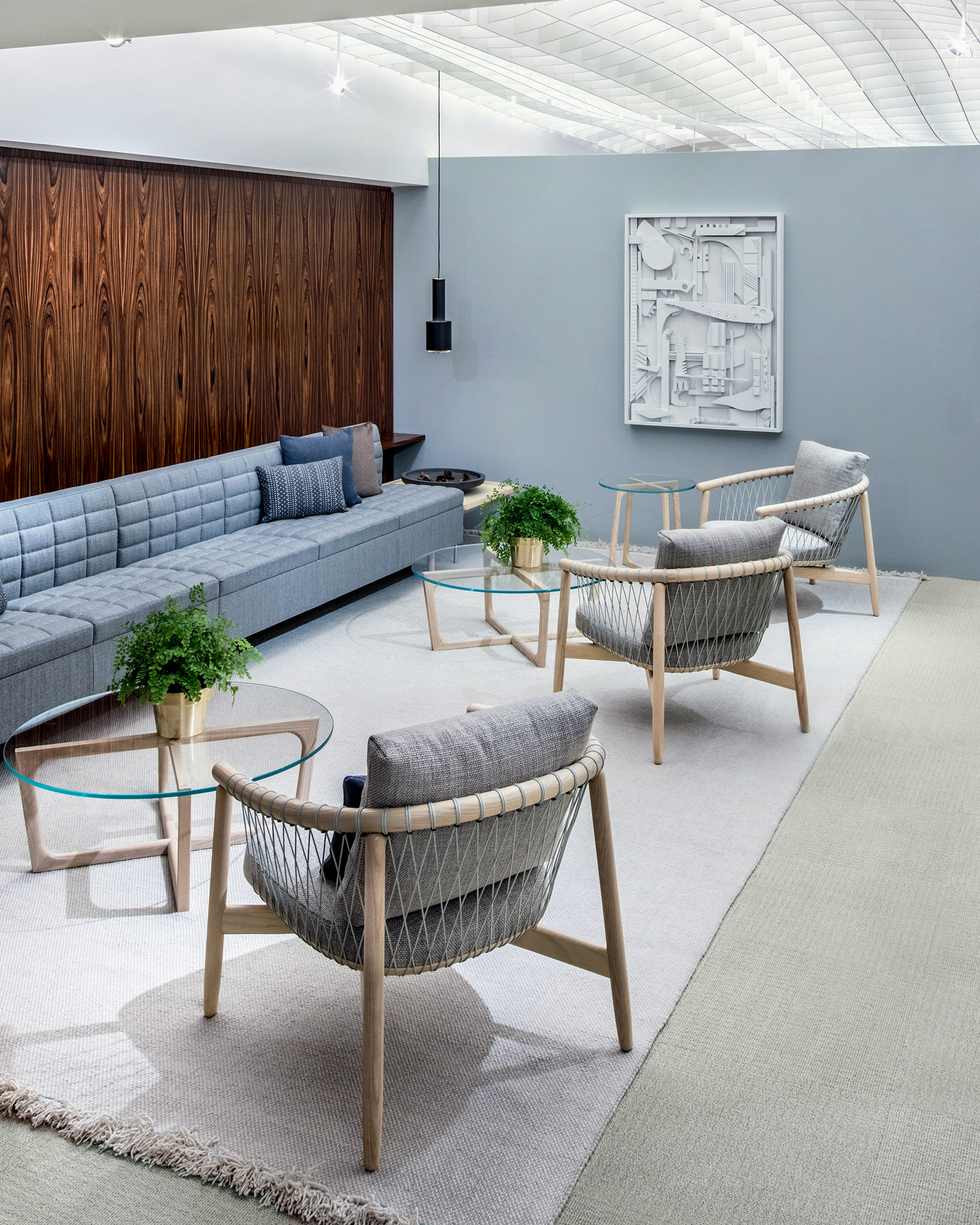A casual meeting space featuring light gray Crosshatch lounge chairs and light blue Tuxedo Classic Lounge Seating.