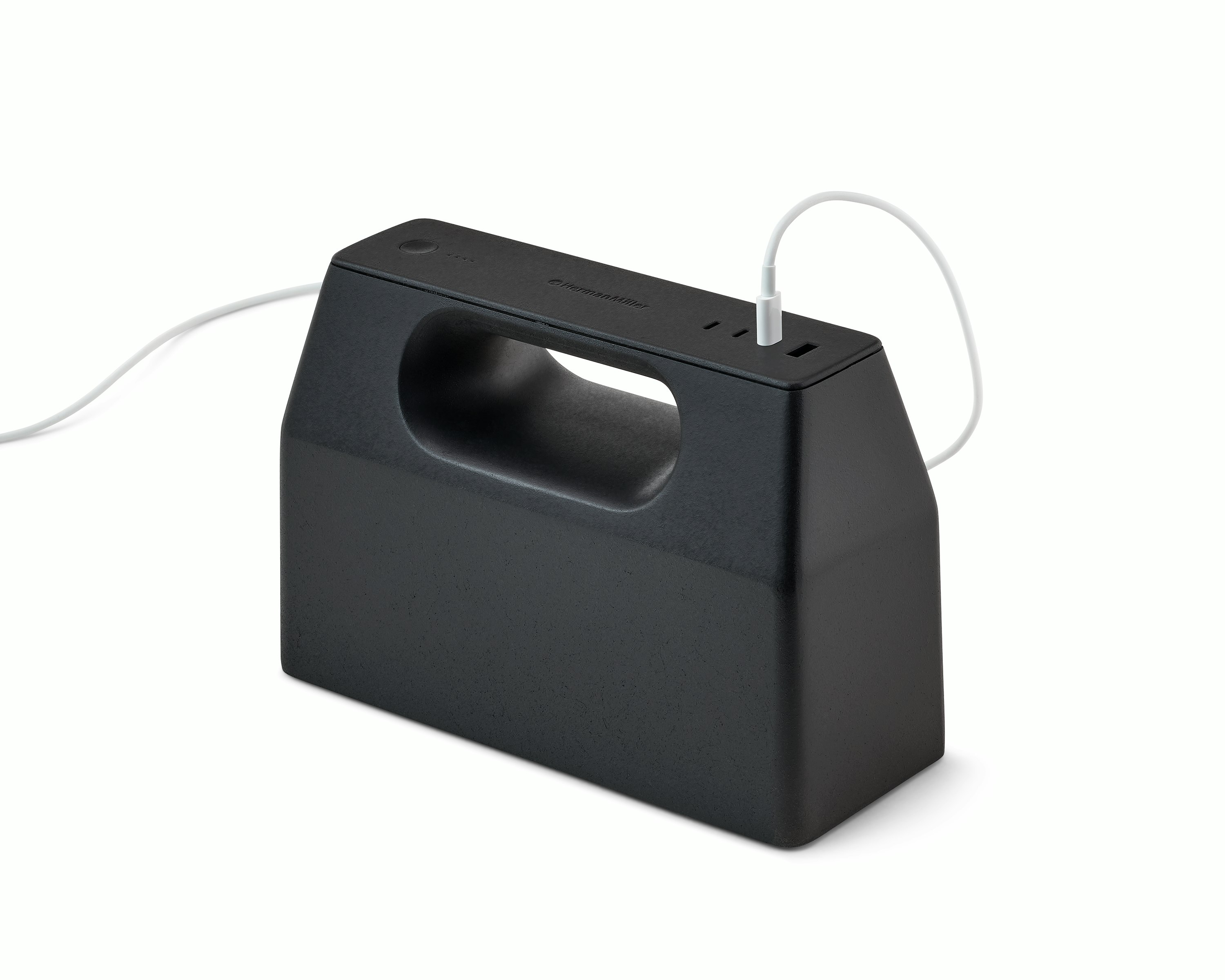 Black OE1 Powerbox with white USB-C cable plugged into it, viewed from an angle.