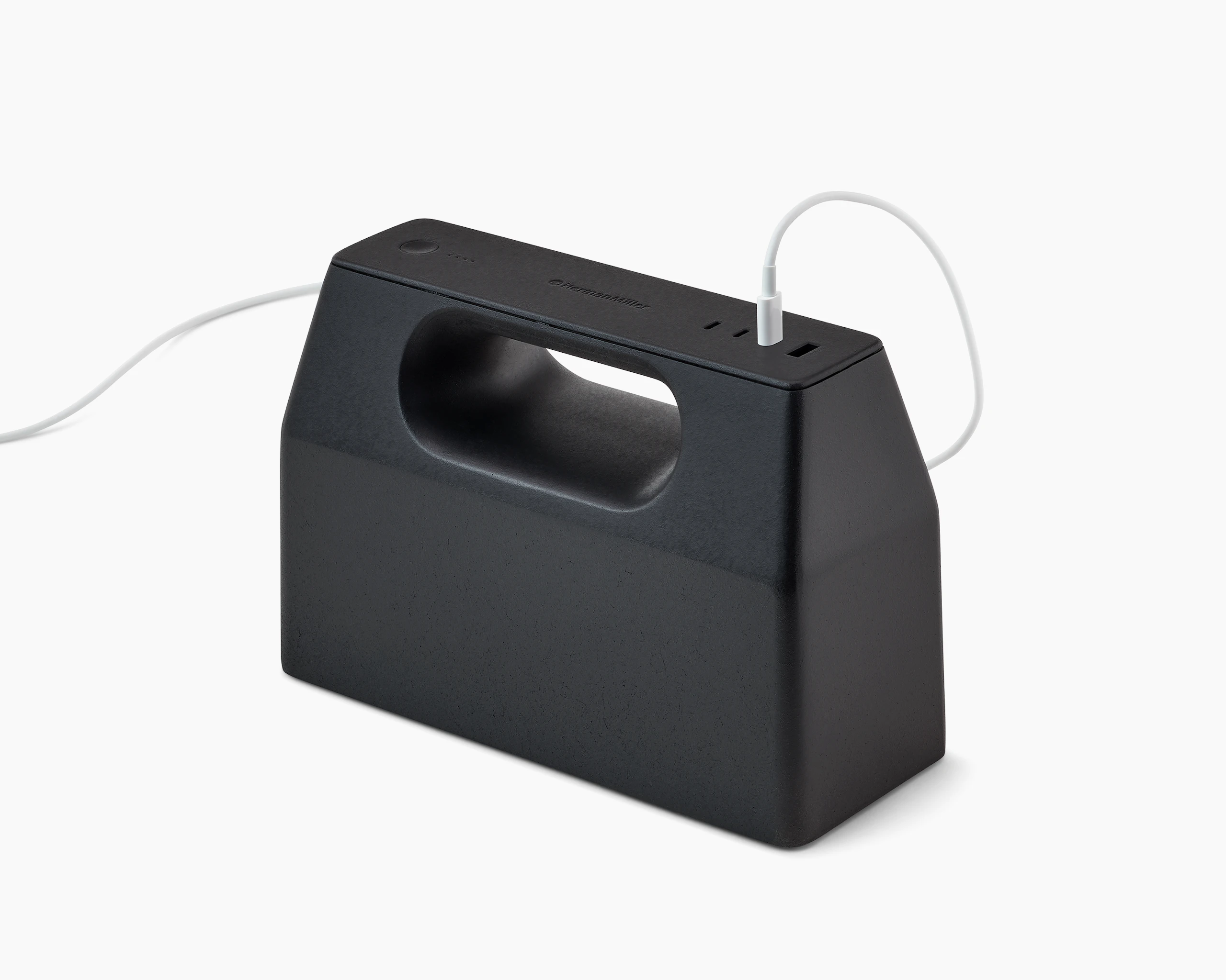 Black OE1 Powerbox with white USB-C cable plugged into it, viewed from an angle.