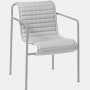 Three quarter view of a Palissade Dining Armchair Quilted Cushion in light grey.