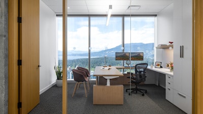 A private office at Blakes law firm - furnished with Herman Miller Aeron chairs and HAY About A chairs - overlooking mountains in Vancouver