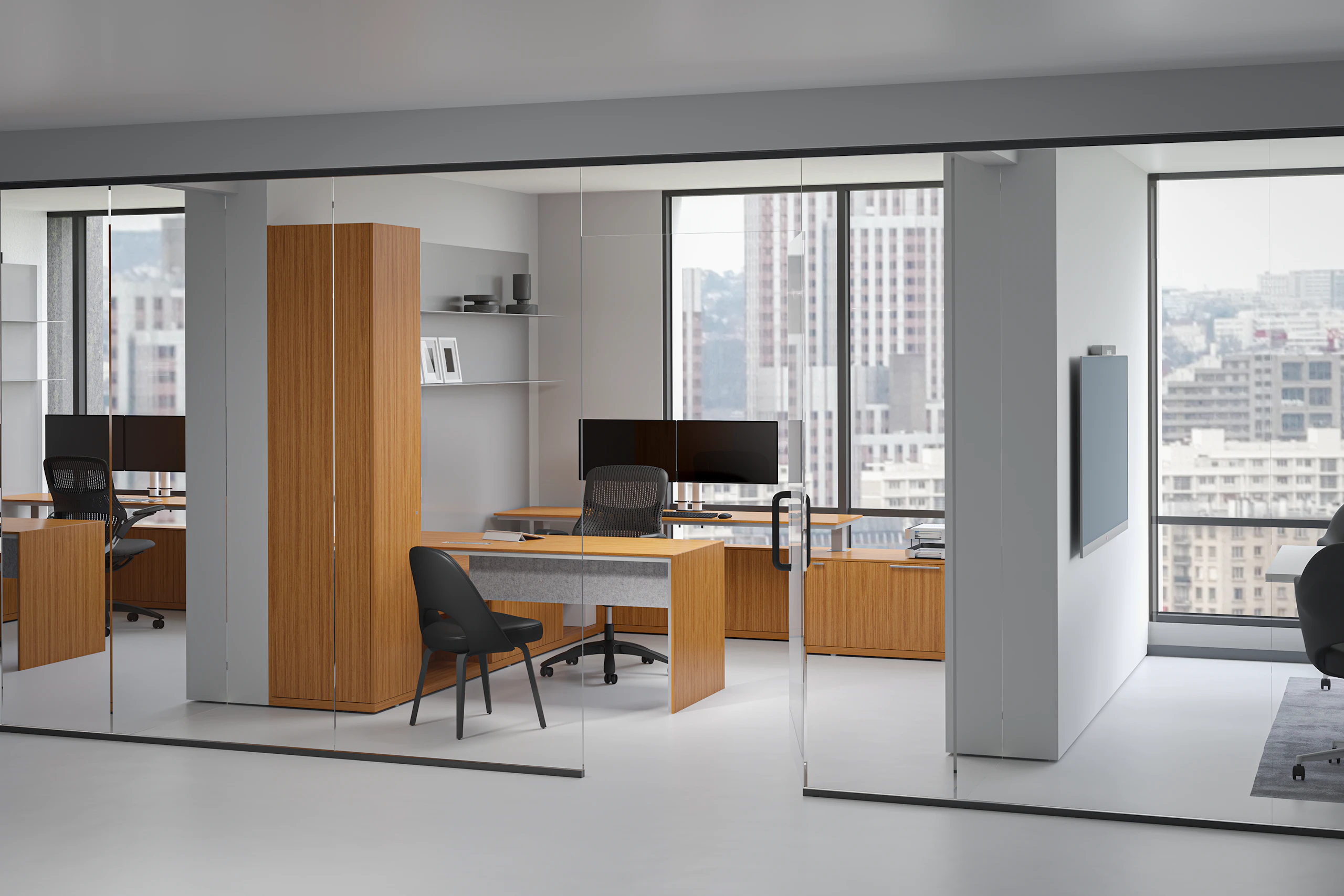 A private office featuring a height-adjustable table, workwall, shelves and credenzas in a light cherry premium wood veneer finish.