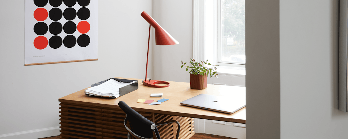AJ Table Lamp, Line Desk, Eames Aluminum Group Chair, and Color Balance Wall Print in a home office setting