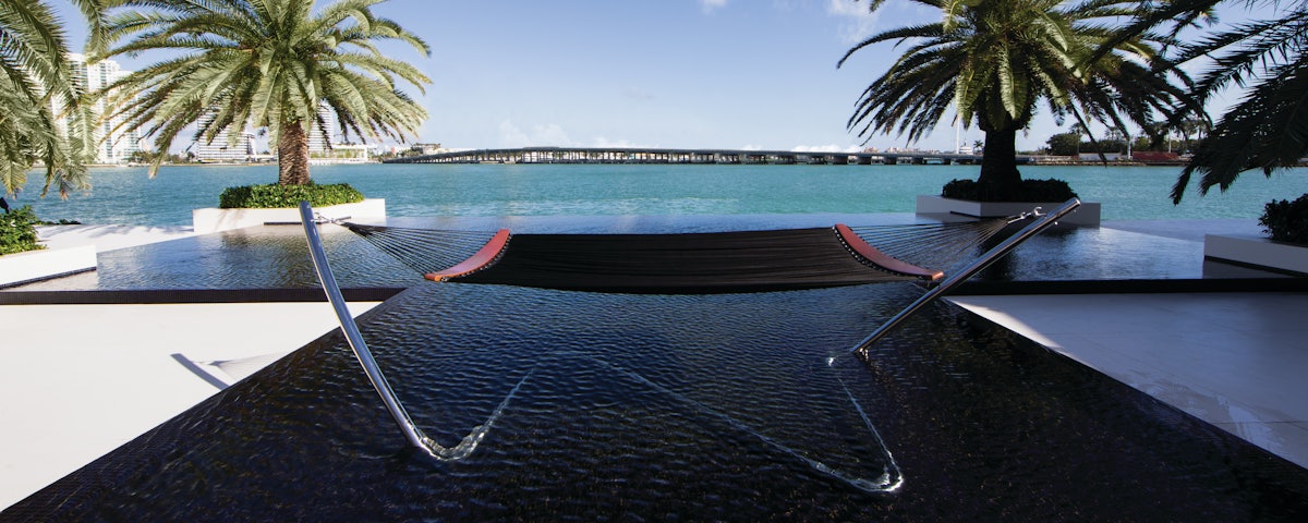 Tuuci Hammock at poolside setting overlooking ocean bay and bridge