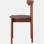 Profile view of a walnut Comma Chair.