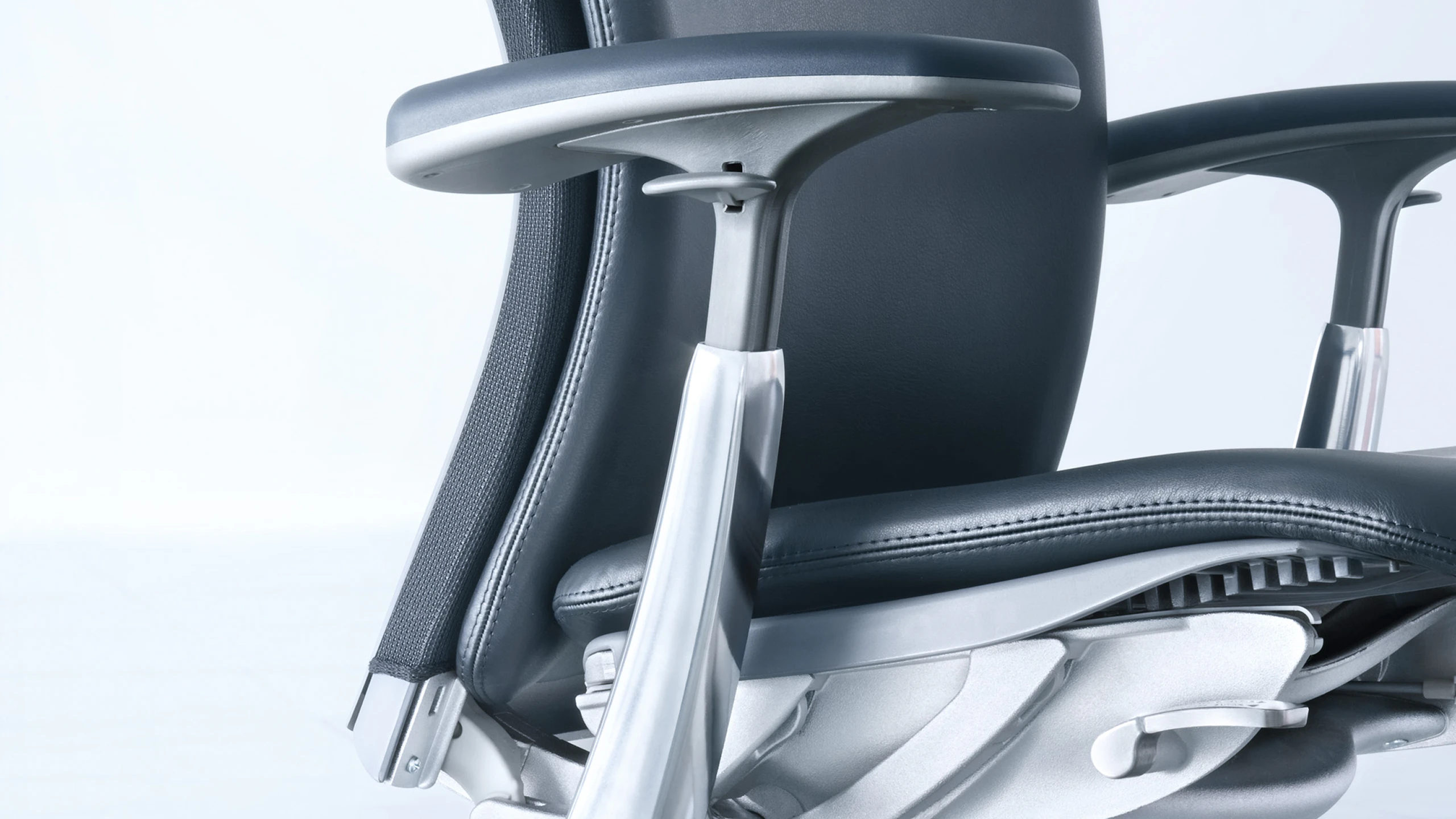 A 3/4 front view of a Knoll Life Chair with a black leather seat and silver frame