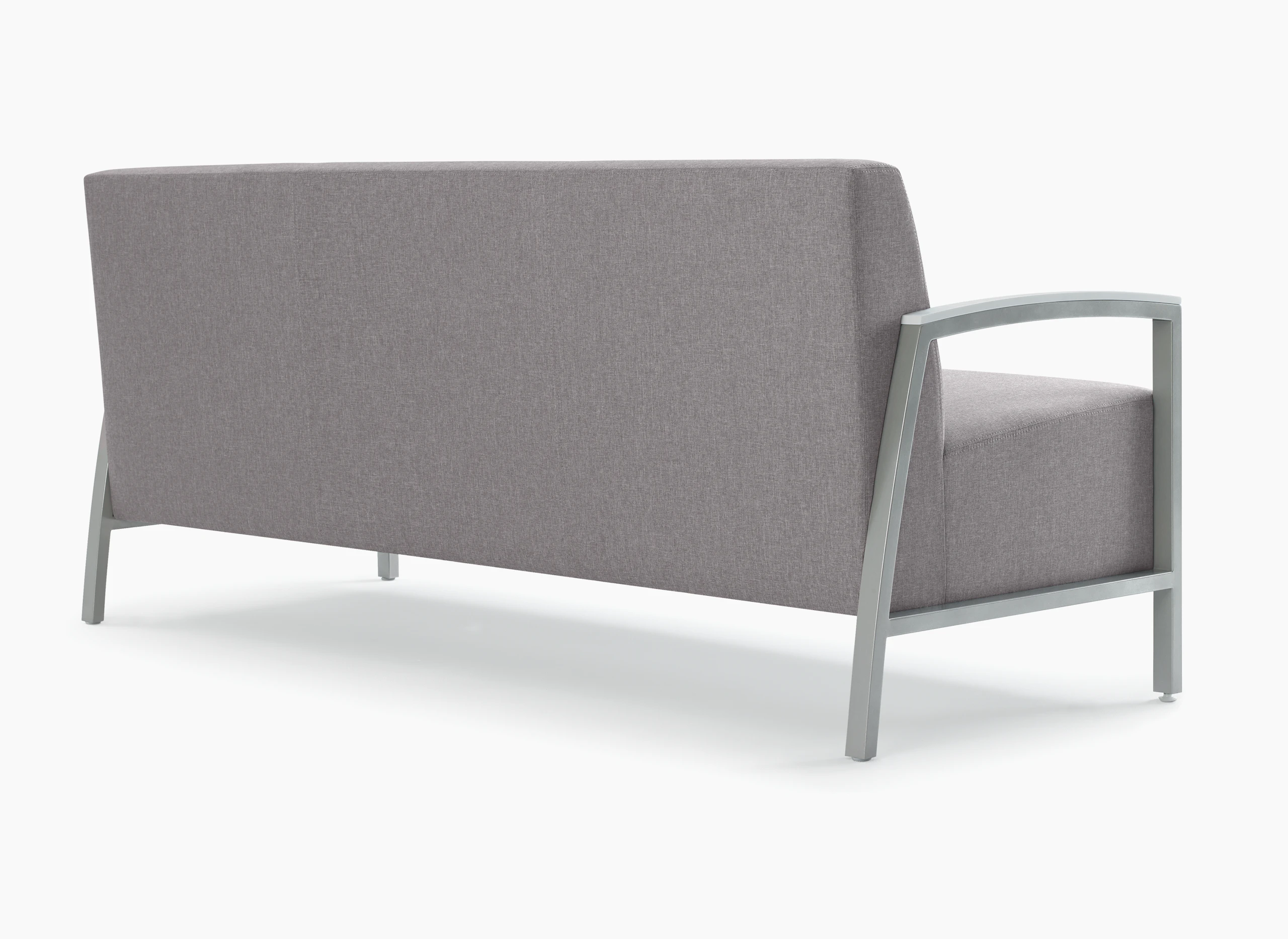 Back three-quarter view of Brava ModernLounge Seating (sofa) with solid surface arm caps.