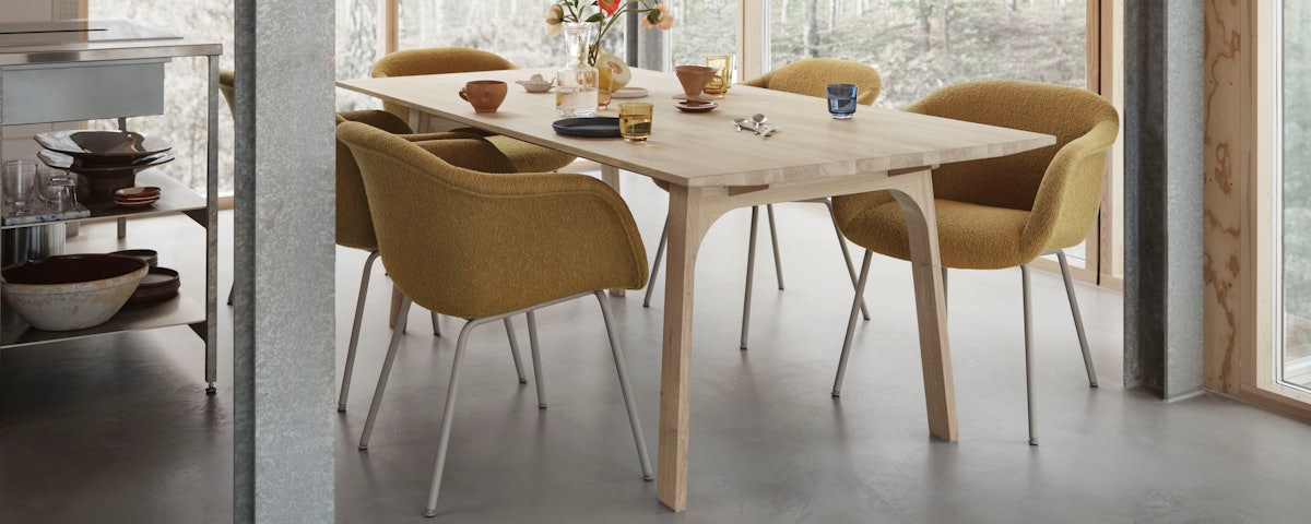 Five Fiber Soft Armchairs surrounding a dining table in a dining room setting