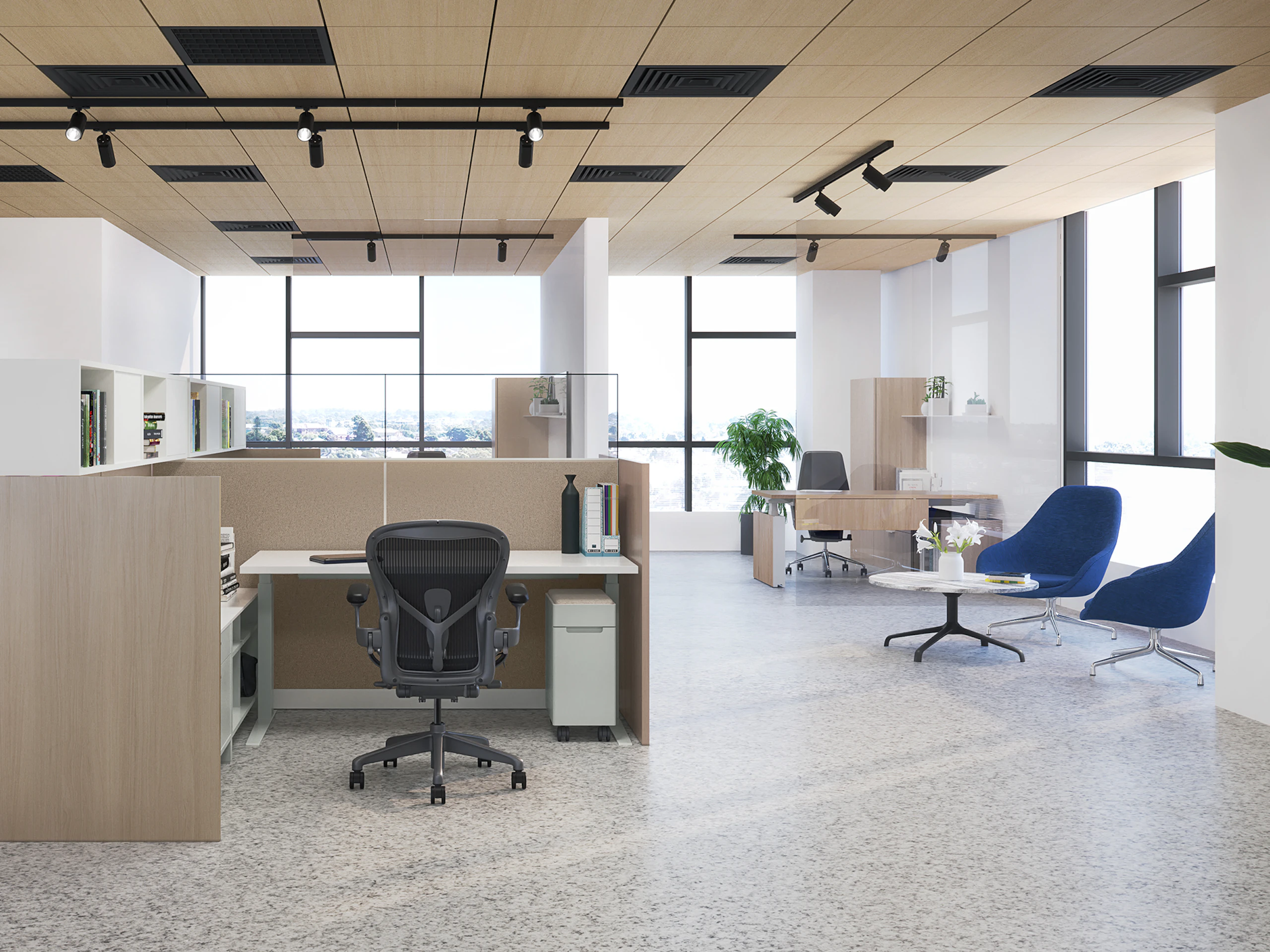 Traditional workplace showing a personal workspace with white Ambit Workspace Solutions product and black Aeron chairs.