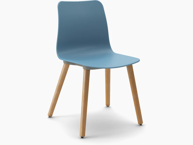 White sweep view of blue polypropylene seat shell on oak dowel 4 leg base.