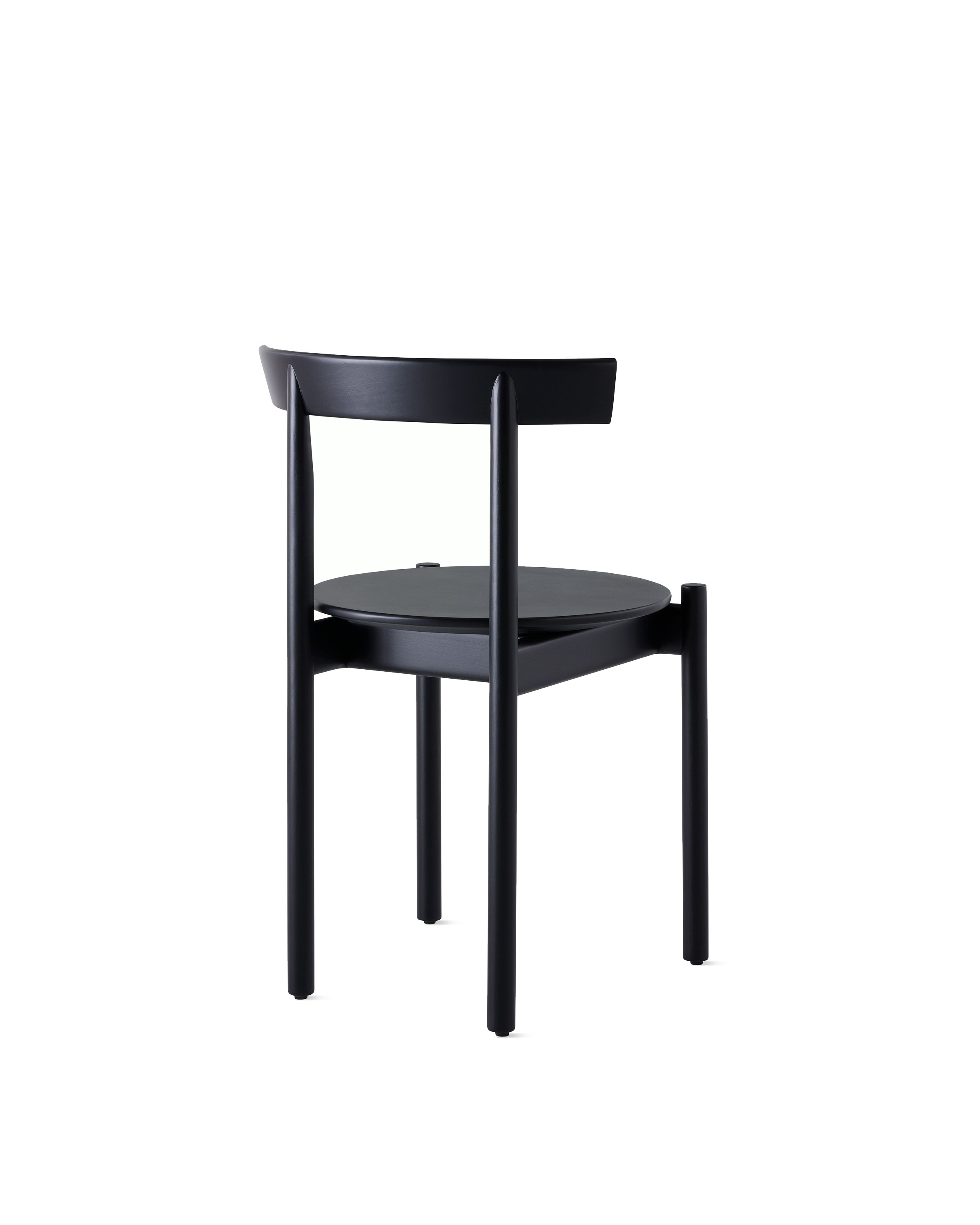 A black Comma Chair, viewed from the back at an angle.