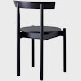 A black Comma Chair, viewed from the back at an angle.