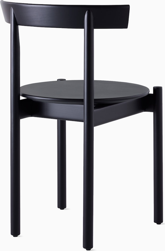 A black Comma Chair, viewed from the back at an angle.