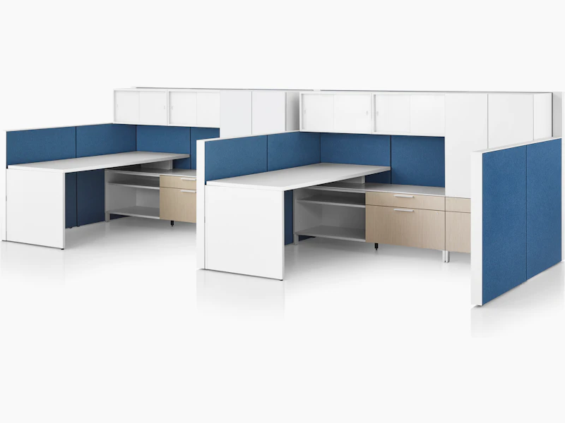 Canvas Wall workstation with blue panels and white overhead storage.