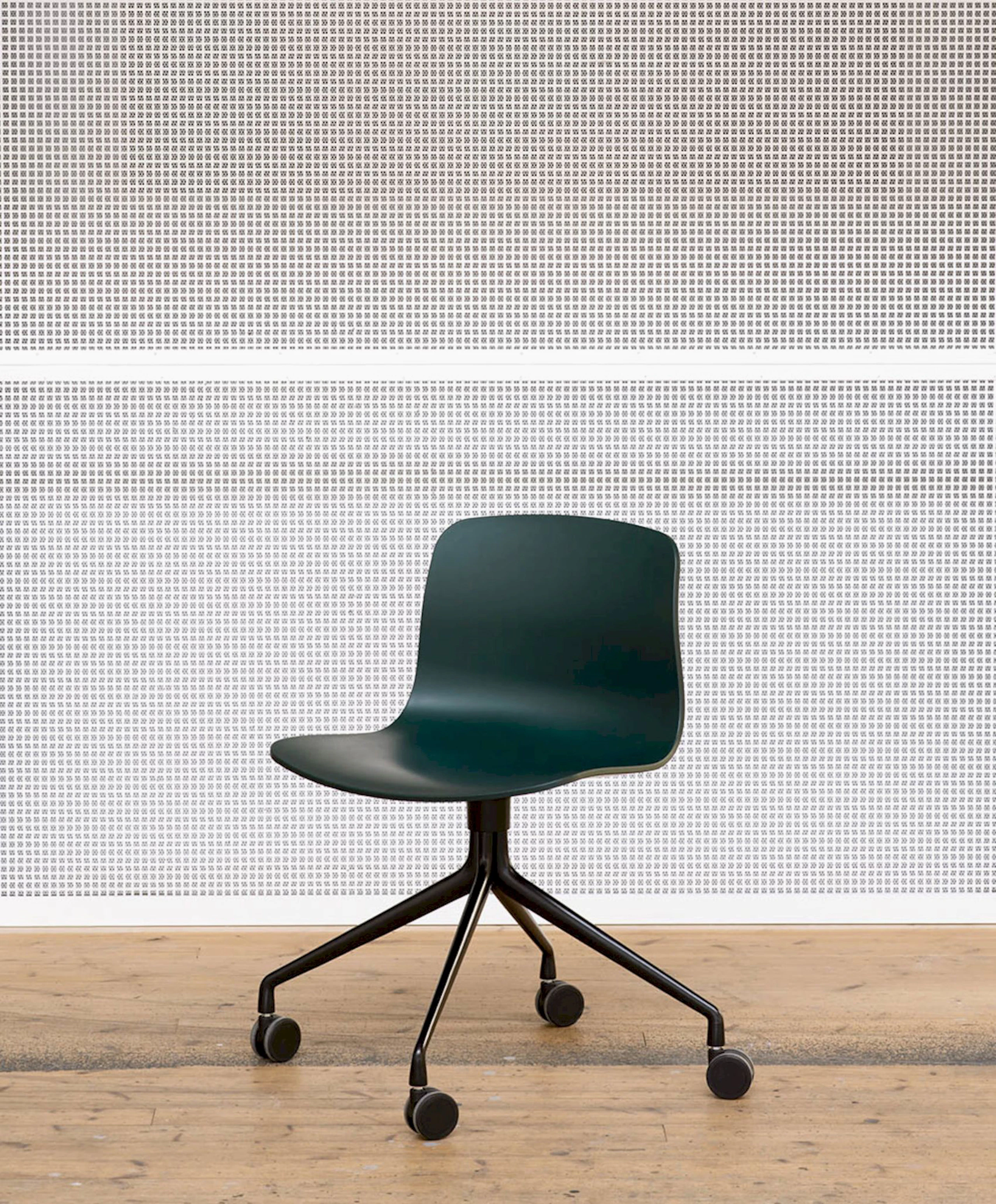 Green, 4-star black swivel base About A Chair, Office, standing alone against a wall.