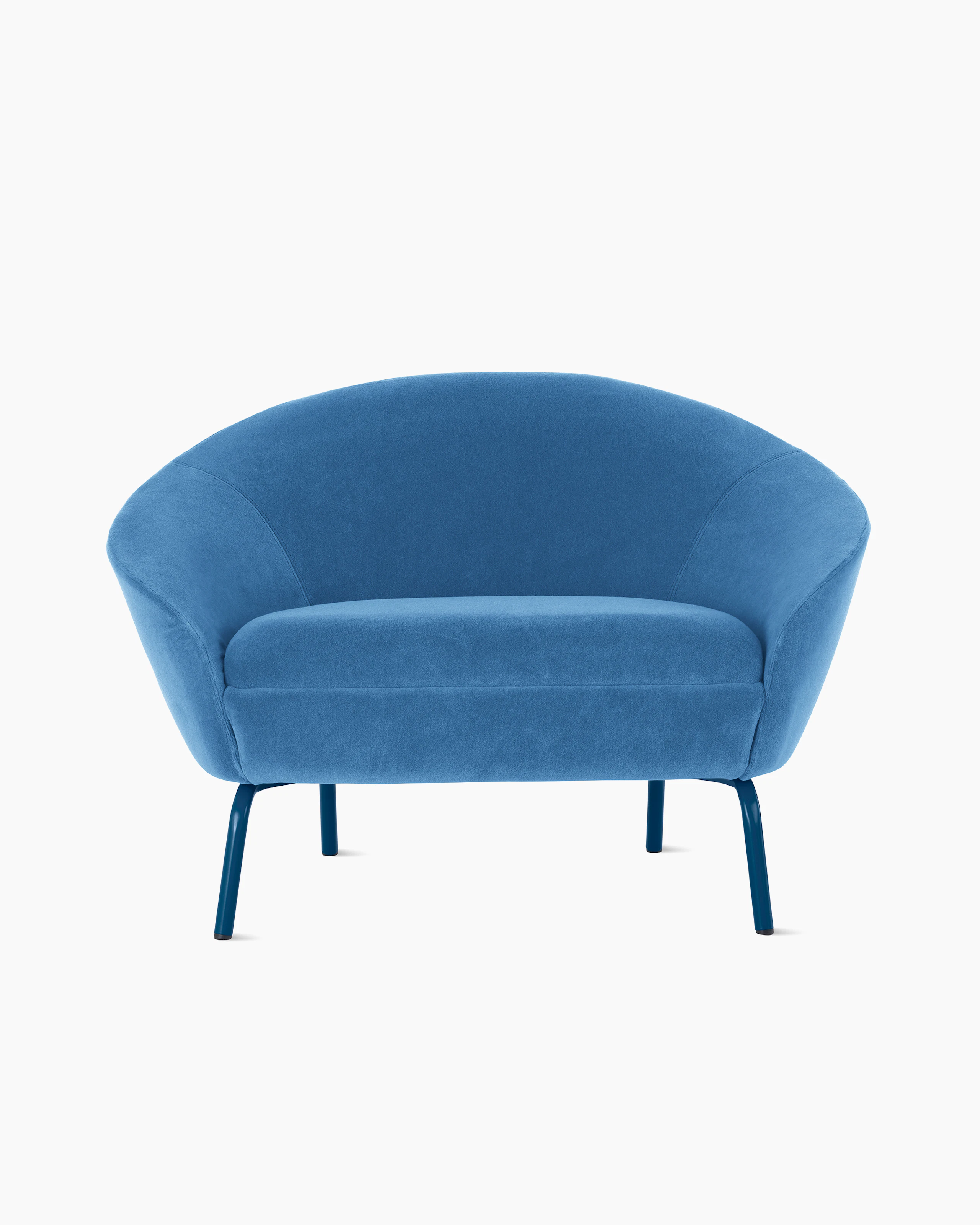 White sweep shot of turquoise blue upholstered Ever armchair on dark blue steel legs.