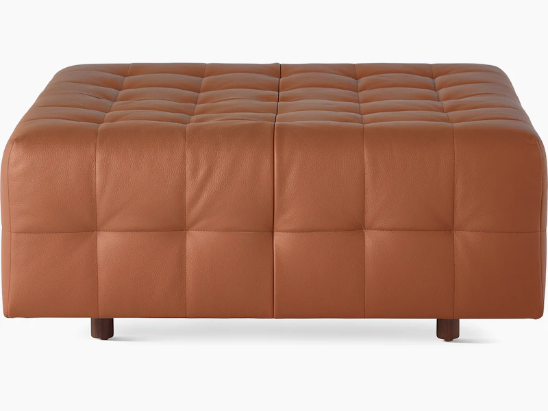 A Rapport ottoman upholstered in leather.
