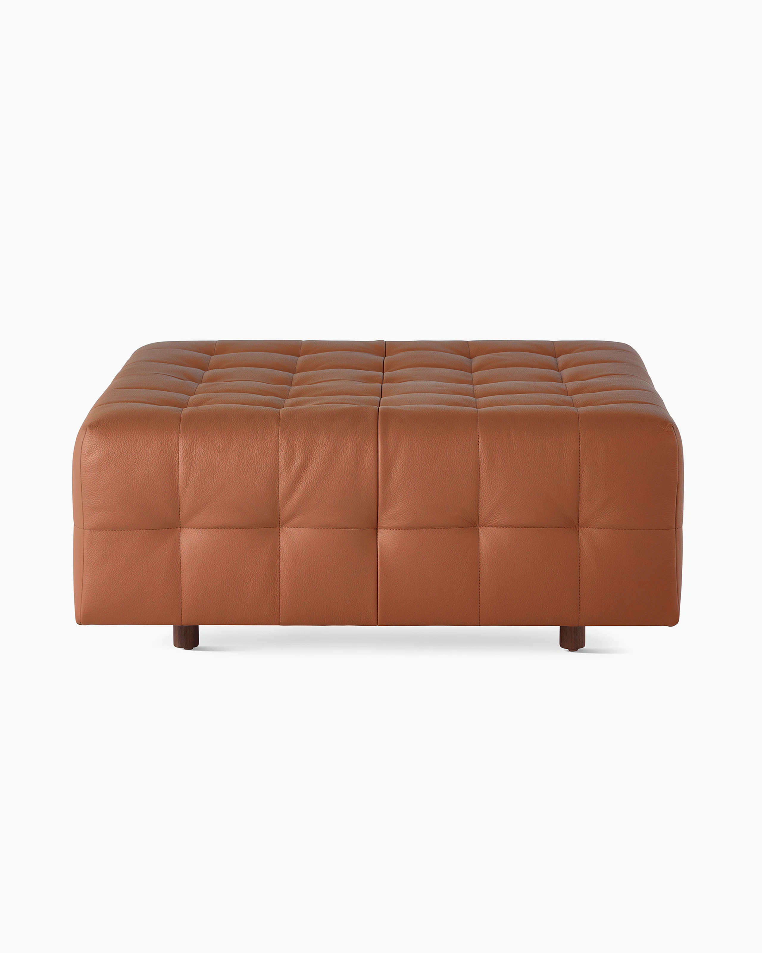 A Rapport ottoman upholstered in leather.
