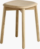 A front angle view of the Soft Edge 72 Stool in oak.