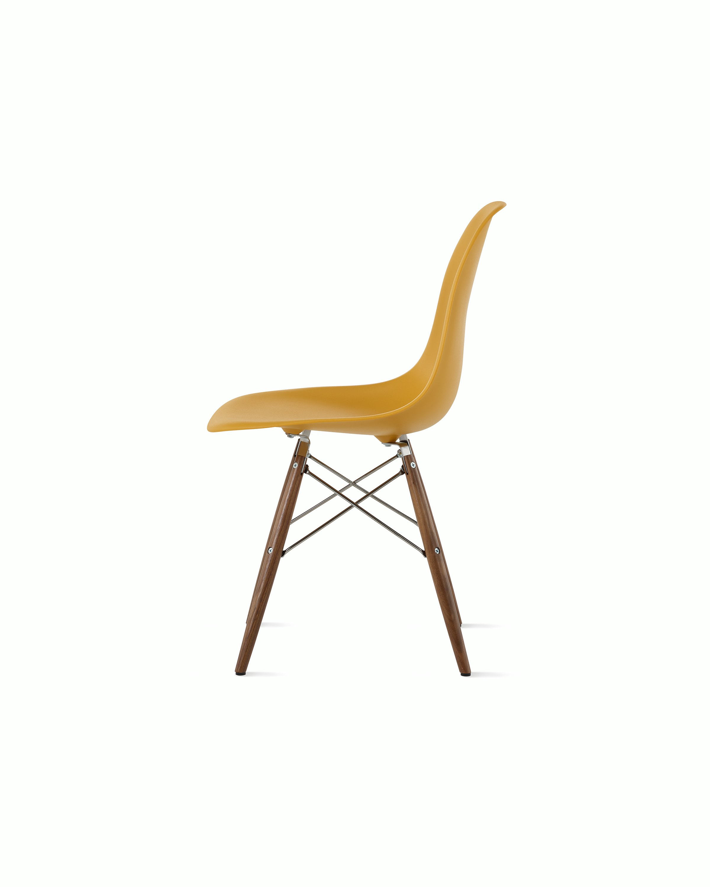 Side of deep yellow plastic shell chair on dowel-base legs.