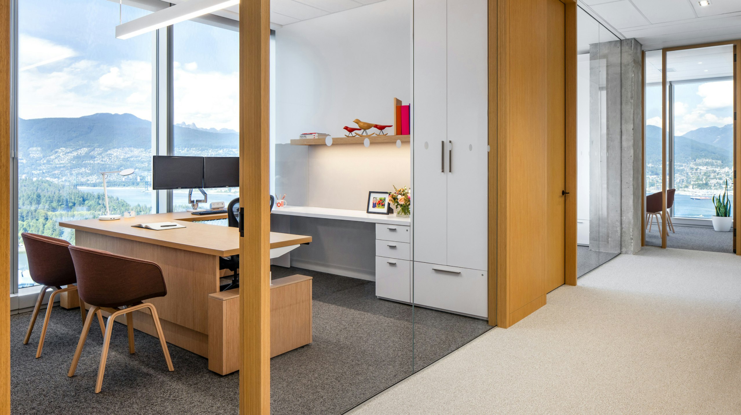 A private office at Blakes law firm - furnished with Herman Miller Aeron chairs and HAY About A chairs - overlooking mountains in Vancouver