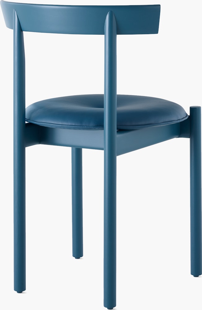 A blue Comma Chair with a seat pad, viewed from the back at an angle.
