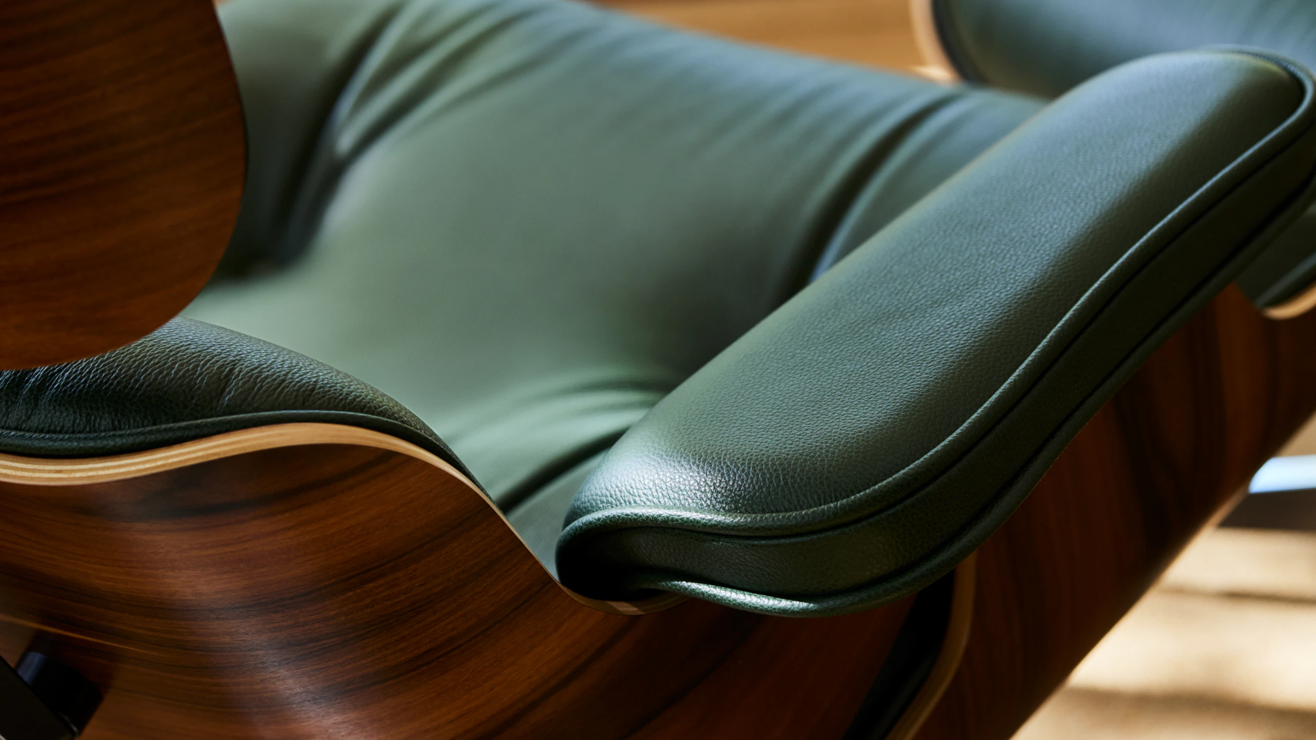 An Eames Lounge Chair and Ottoman viewed from the back at an angle