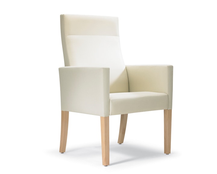 A three-quarter view of a Brava 863 high-back patient chair in white textile with fully upholstered arms.