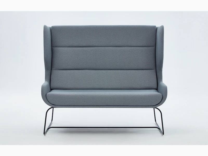 White sweep shot of grey Hush Sofa with black sled base.