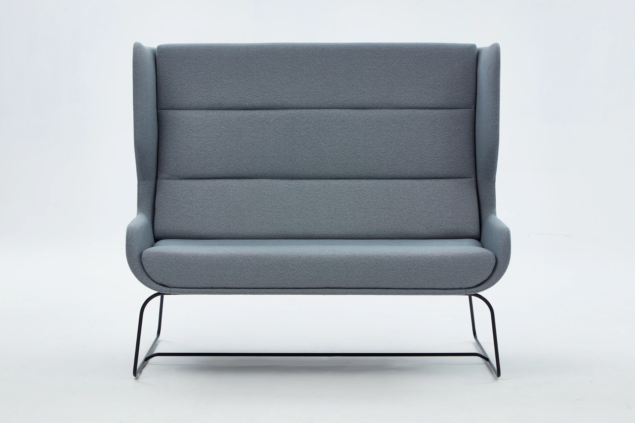 White sweep shot of grey Hush Sofa with black sled base.