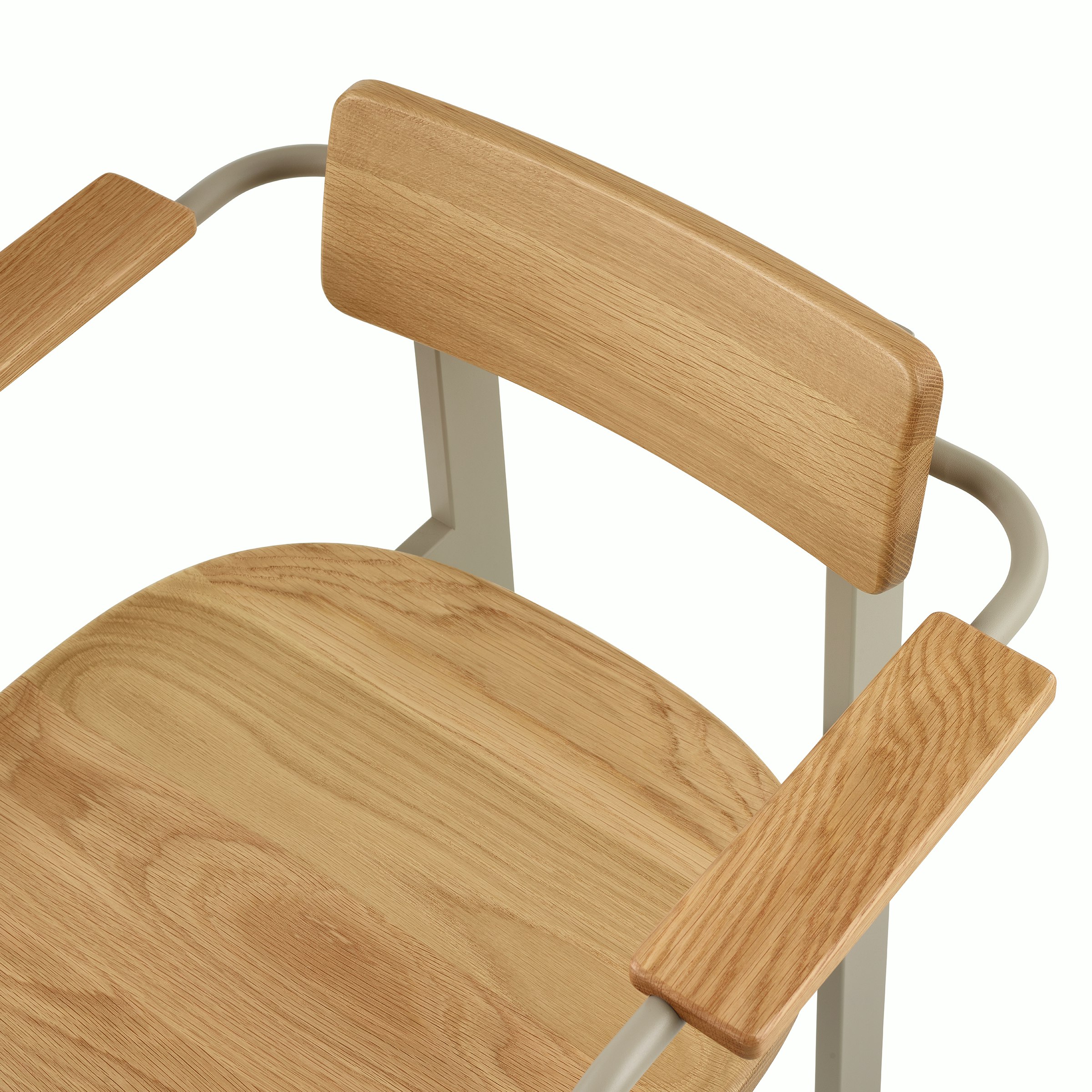 A close-up of a Betwixt Chair with oak backrest, seat, and arms, with a grey frame.
